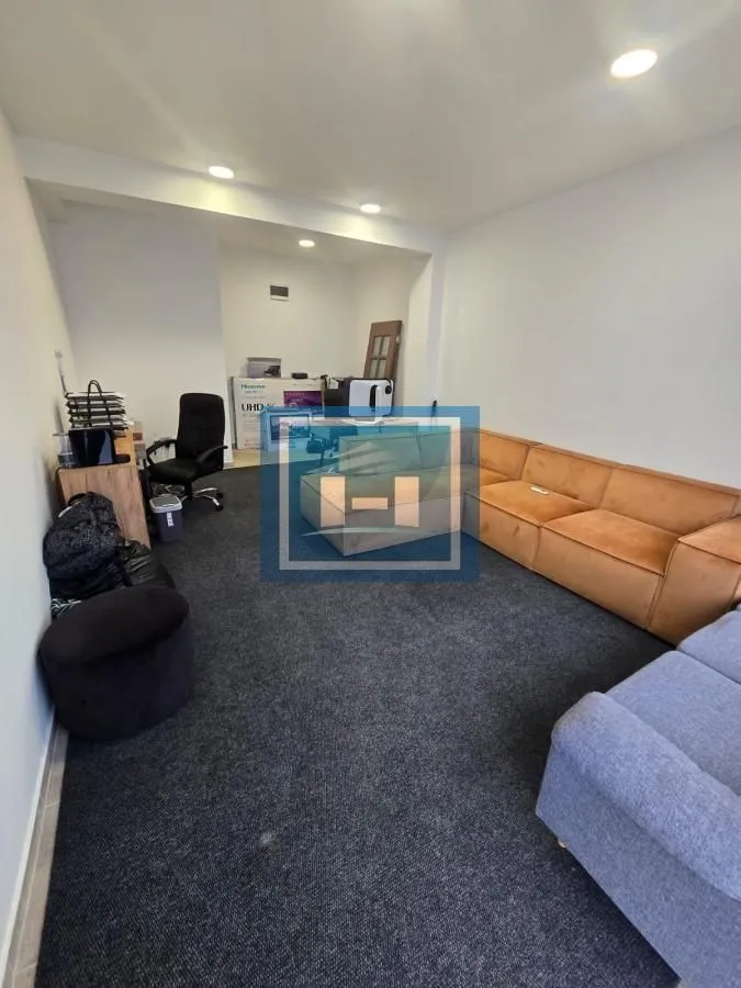 Spacious living room with a sectional sofa and a desk.