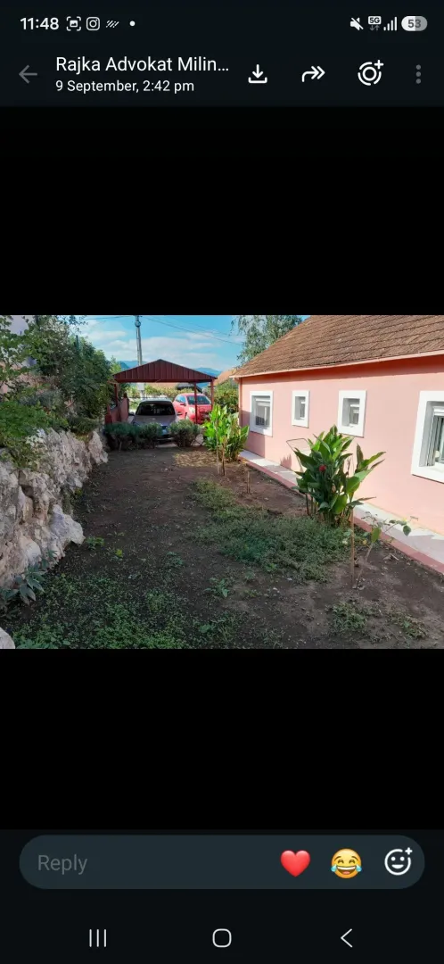 Yard of the house with a landscaped garden and covered parking.