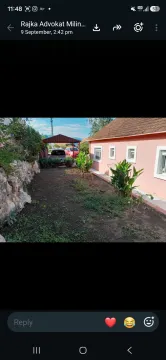 Yard of the house with a landscaped garden and covered parking. - image 7
