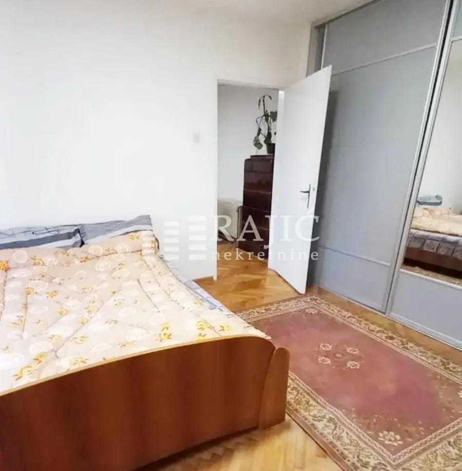 Bedroom with a double bed, large wardrobe, and rug.