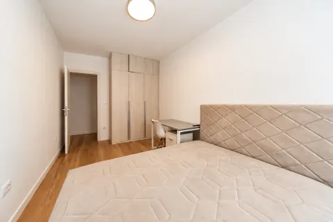 Furnished bedroom with a double bed, wardrobe, and a desk. - image 3