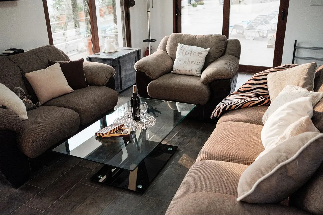 Comfortable living room with a seating set and a glass coffee table.