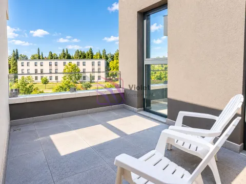 Spacious terrace with a glass railing and white plastic chairs. - image 9