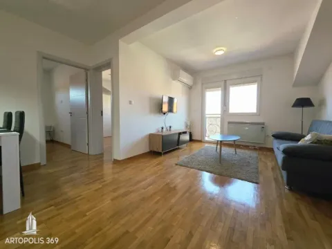 Living room with a sofa, TV, and access to the terrace. - image 4