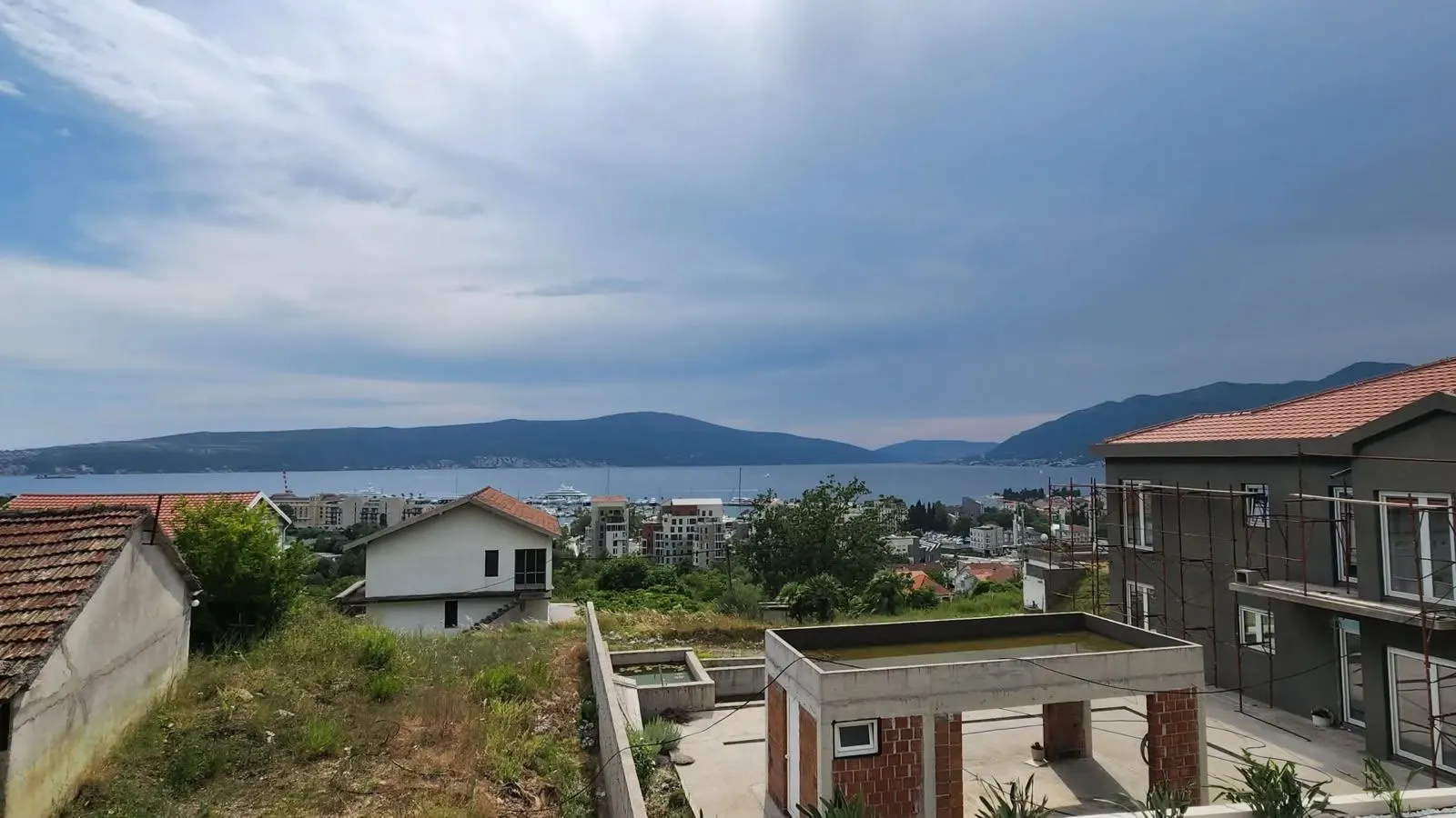 View of the sea and surrounding settlement from a terrace or property under construction.