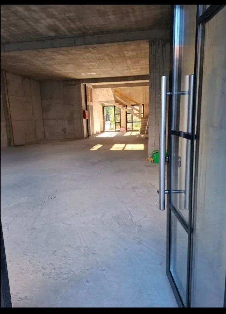 View through an open door into an unfurnished commercial space under construction.