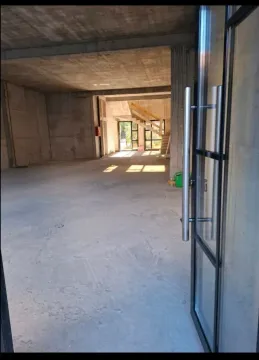 View through an open door into an unfurnished commercial space under construction. - image 2