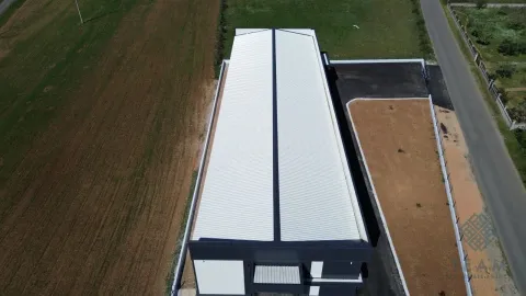 Aerial view of the building with yard and access road. - image 5