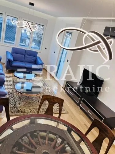 Living room with a sofa set and dining area.