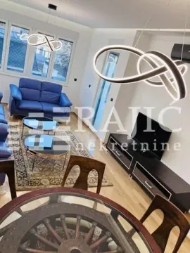 Living room with a sofa set and dining area. - image 2