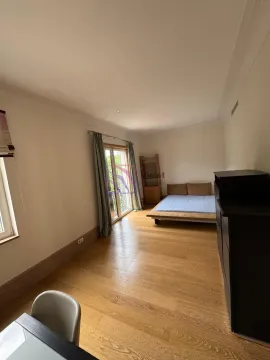 Spacious bedroom with wooden flooring and access to the terrace. - image 17
