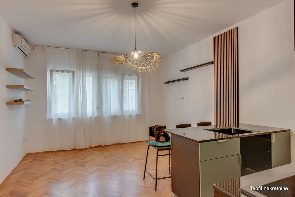 Small kitchen with an island and parquet flooring.