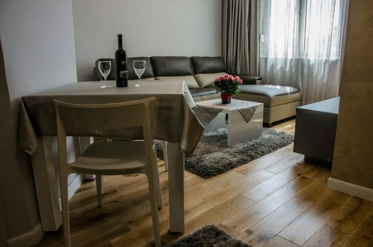 Bright living room with a dining table and a corner sofa.