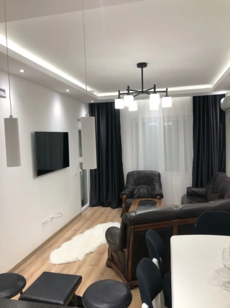 Modern living room with seating area and dining space.