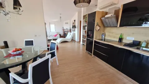 Modern kitchen connected to the dining area and living room. - image 5