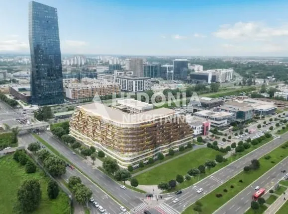 Aerial view of a modern residential building with the surrounding urban landscape.