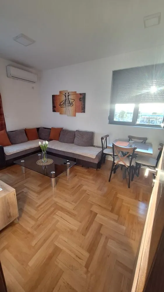 Living room with a sectional sofa, coffee table, and dining area.