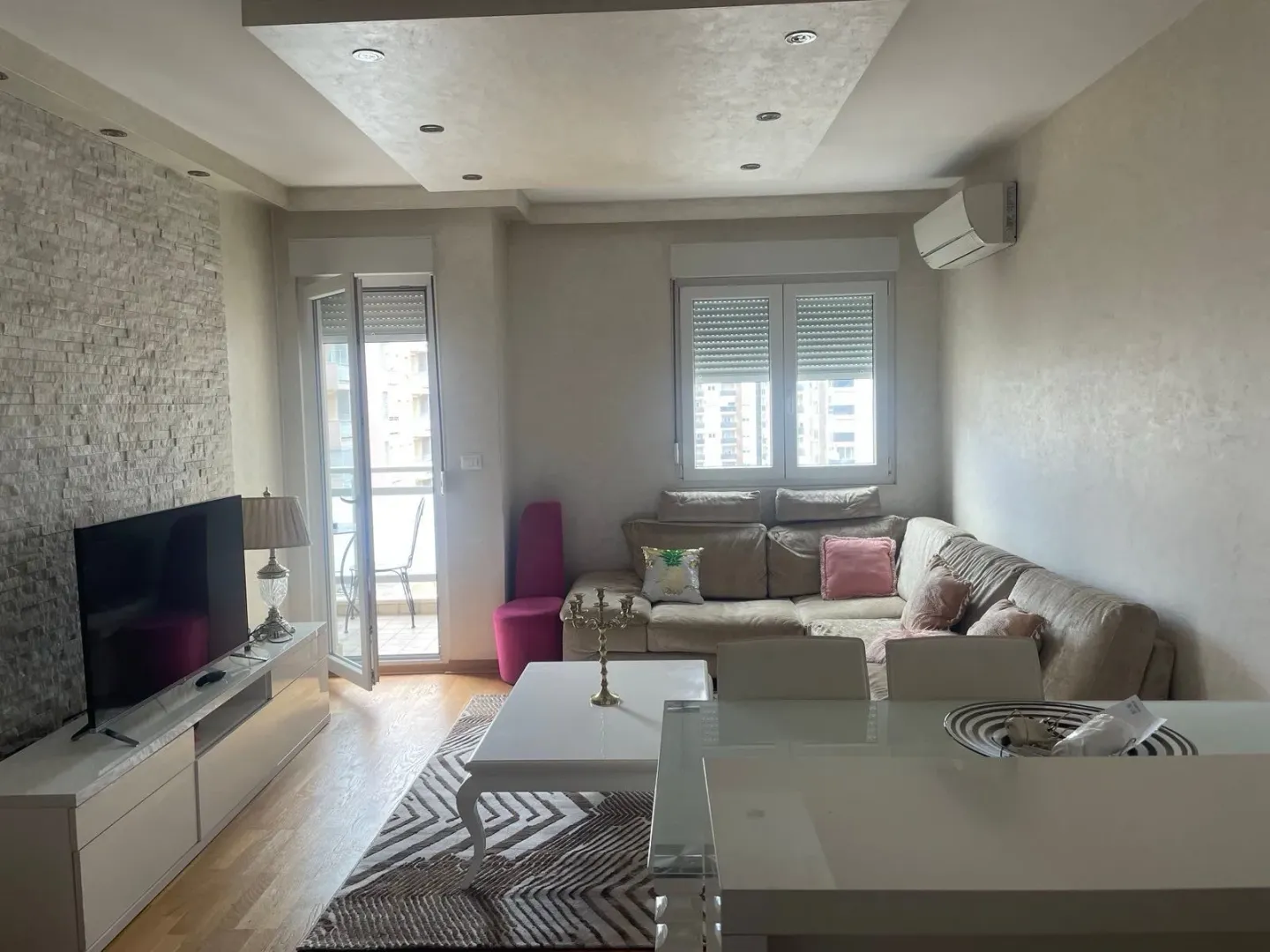 Living room with a sofa, TV, and dining table.
