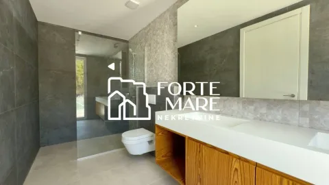 Modern bathroom with a washbasin and a walk-in shower. - image 8