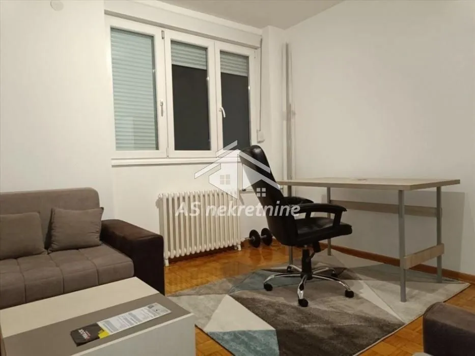 Living room with a desk and a sofa.
