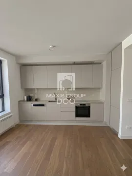 Modern kitchen with fitted units and parquet flooring. - image 2