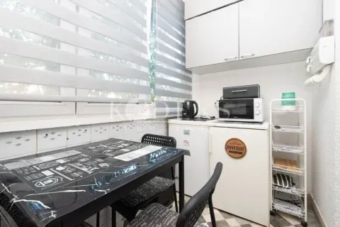 Smaller kitchen with a dining table and chairs by the window. - image 4
