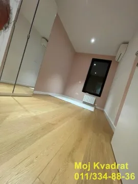 Small room with wooden flooring, mirrored wardrobe, and air conditioning. - image 12