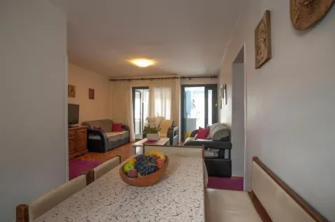 Living room with a dining area and furniture. - image 12