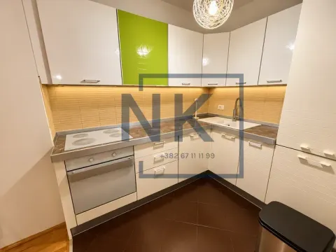 Modern corner kitchen with white and green cabinets. - image 7