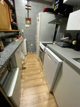 Small equipped kitchen with white goods and wooden elements. - image 9