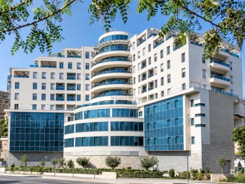 Exterior view of a modern residential building with glass features. - image 12