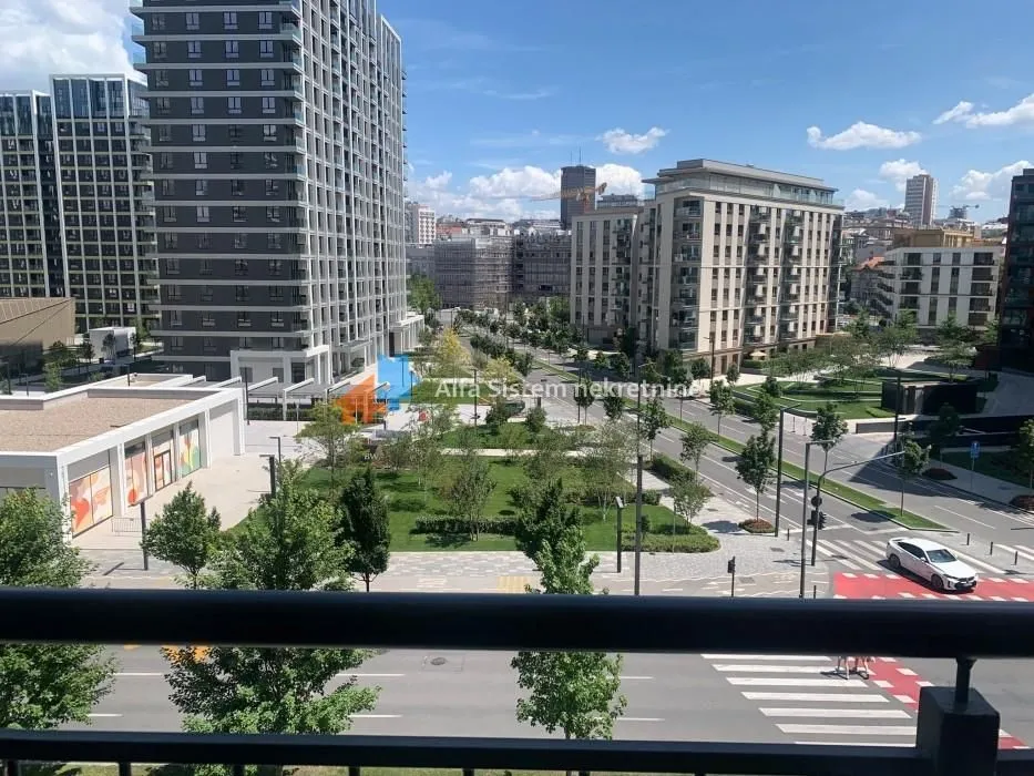 View from the terrace overlooking city streets and modern buildings.