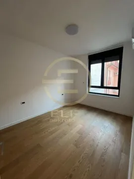 Empty room with hardwood flooring and a window. - image 4