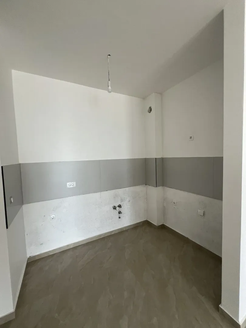 Empty interior space with installations prepared for a kitchen.