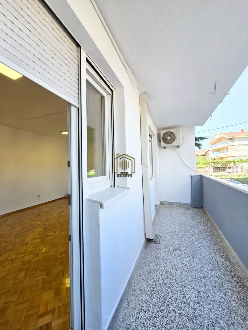 Spacious covered balcony with a view of the surroundings.