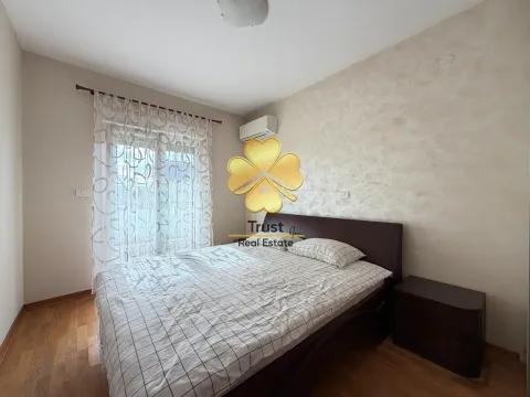 Tidied bedroom with a double bed and a window with curtains. - image 17
