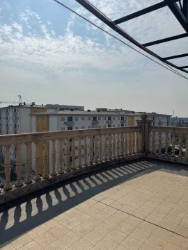 Spacious terrace with a stone railing and a view of surrounding buildings. - image 7