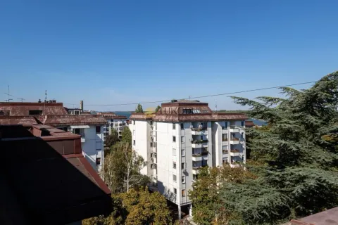 View from the terrace on surrounding residential buildings and greenery. - image 9