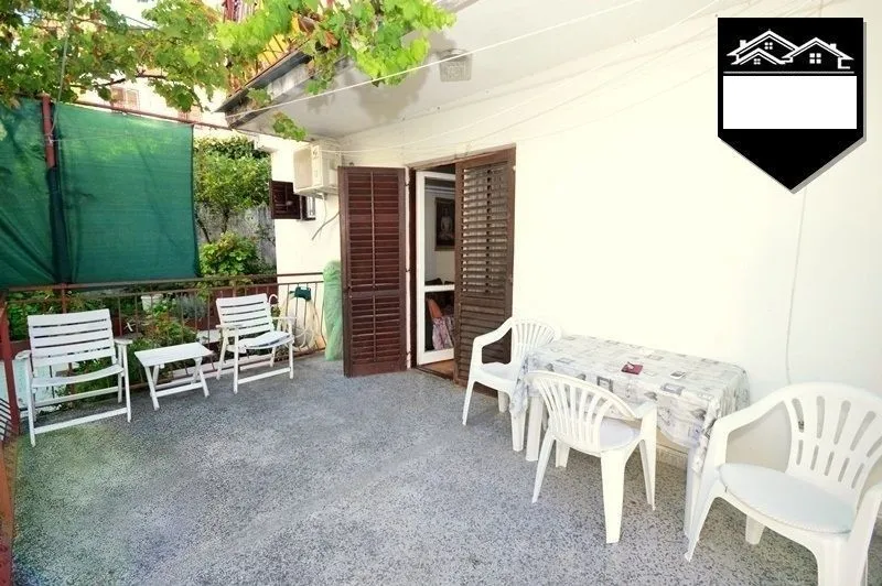 Terrace with outdoor seating in front of the property entrance.