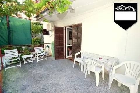 Terrace with outdoor seating in front of the property entrance. - image 8