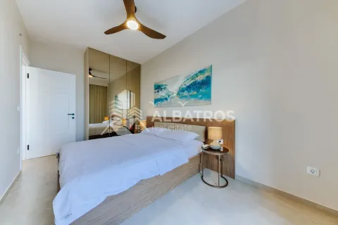 Modern bedroom with a double bed, mirrored built-in wardrobe, and ceiling fan. - image 16