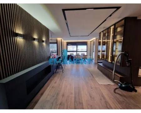 Living room with modern wooden wall panels and recessed lighting. - image 6