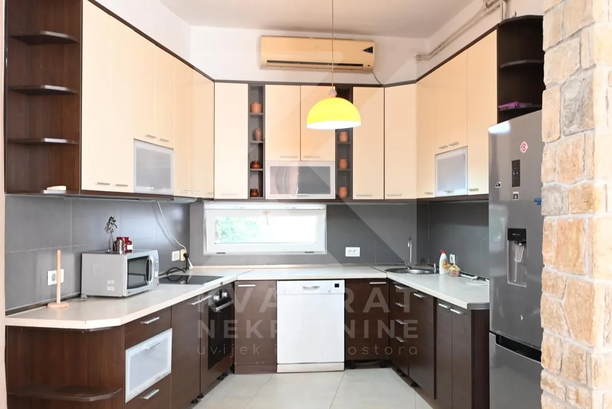 Kitchen equipped with wooden cabinetry and appliances.