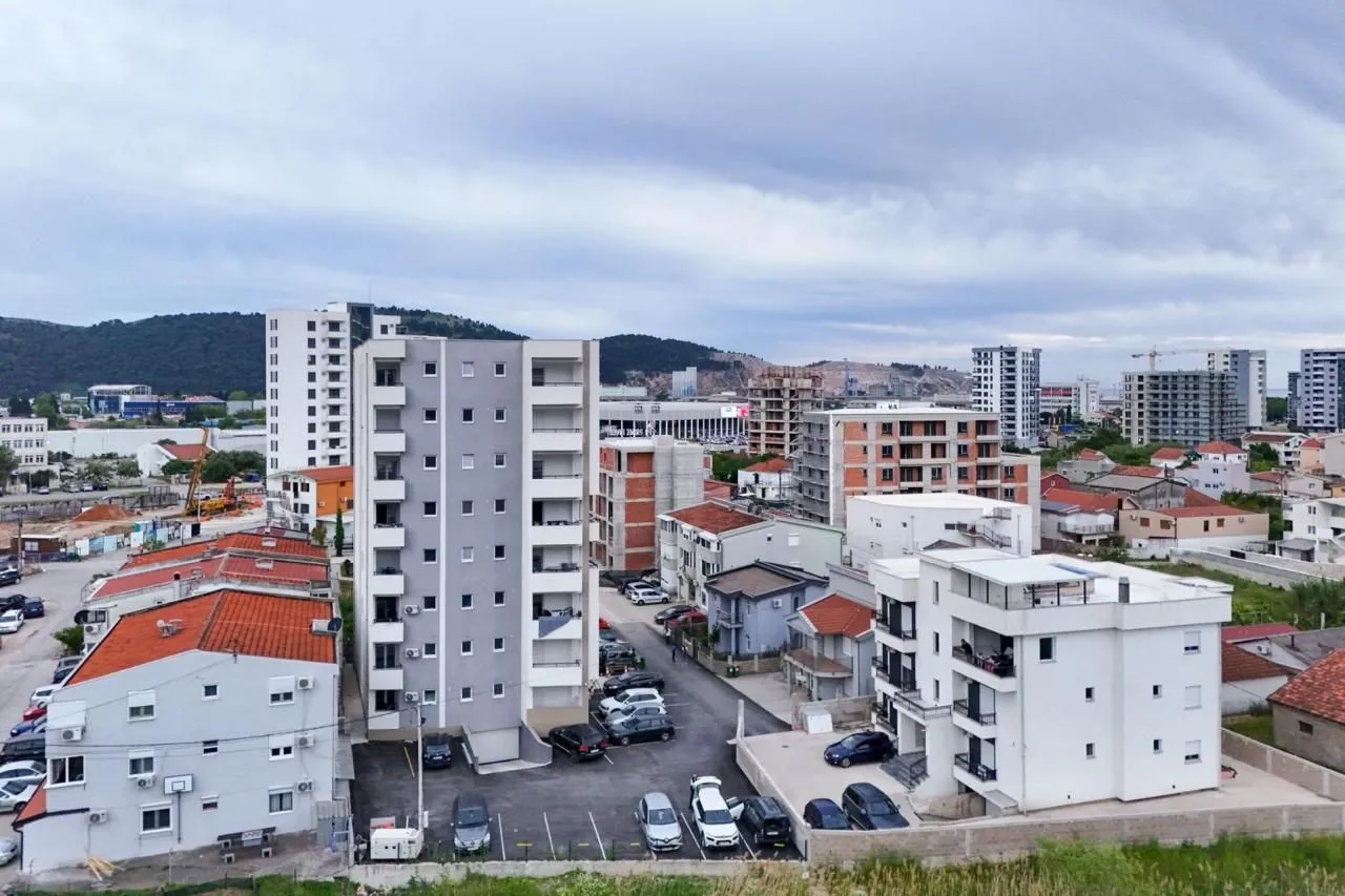 Aerial view of residential buildings and the surrounding neighborhood.