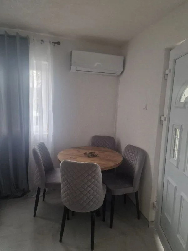 Dining table with four chairs in a bright room.