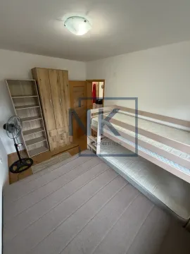 Bedroom with a bunk bed, wardrobe, and shelving unit. - image 6