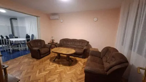 Living room with furniture and parquet flooring, overlooking the dining area. - image 2
