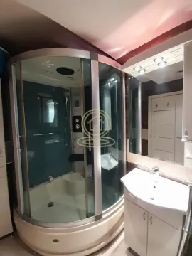 Bathroom with a shower cabin and a washbasin. - image 16