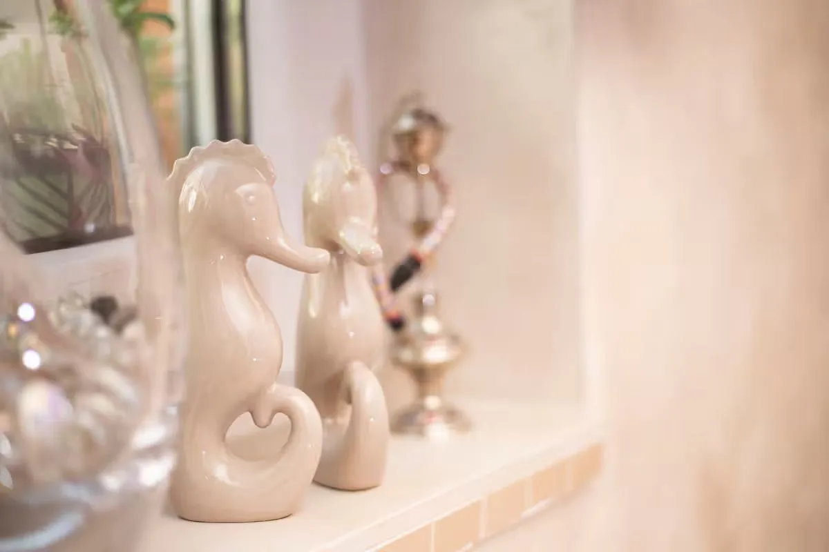 Decorative seahorse figurines on a shelf.