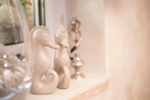 Decorative seahorse figurines on a shelf. - image 18